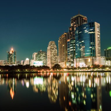 City downtown at night with reflection of skyline clipart