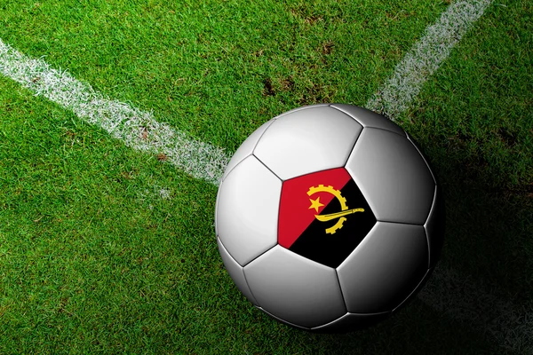 Angola Flag Pattern of a soccer ball in green grass — Stock Photo, Image