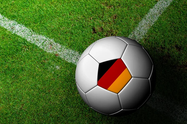 Tyskland flagga mönster av en fotboll i grönt gräs — Stockfoto