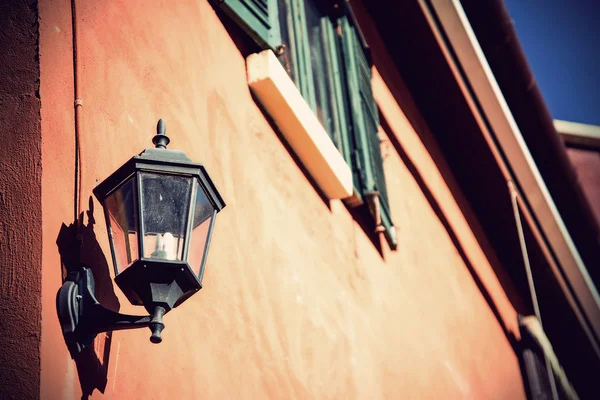 Lamp hanging on brick wall on the street — Stock Photo, Image