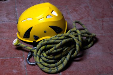 Construction worker hard hat with tools lying on stone antique floor