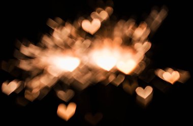 11 bokeh textures in the shape of hearts on a black background