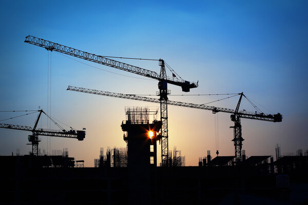 Industrial landscape with silhouettes of cranes