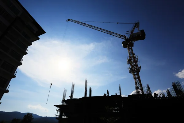 Crane and construction site silhouette — Stock Photo, Image