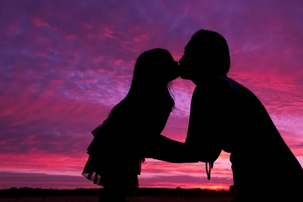 Mother daughter kissing