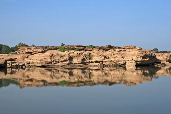 Red stone with water reflection — Stock Photo, Image