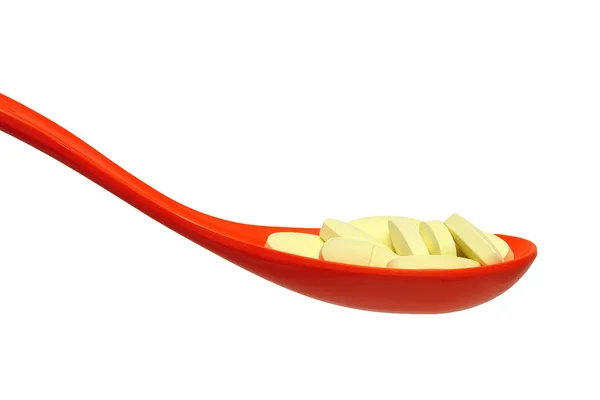 Pillola in un cucchiaio su uno sfondo bianco — Foto Stock