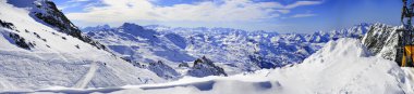 Panorama of Snow Mountain Range Landscape with Blue Sky from 3 Valleys in french Alps clipart