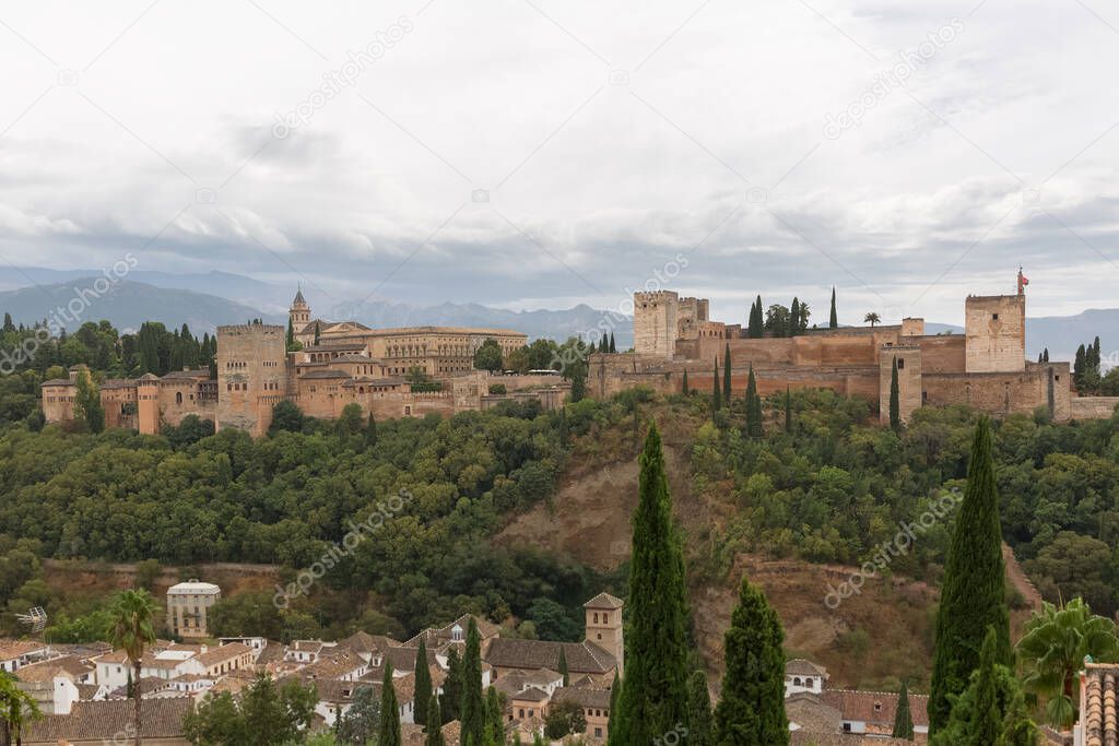 Alhambra Granada Spain - 09 14 2021: View at the exterior facade building at the Alhambra citadel and gardens, view Viewpoint San Nicolas, a palace and fortress complex located in Granada, Spain