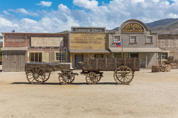 Almeria Spain - 09 15 2021: View at the Oasys - Mini Hollywood, a Spanish Western-style theme park, Western cowboys scenario, old wooden cart, town with traditional stores, Almeria Taberna desert