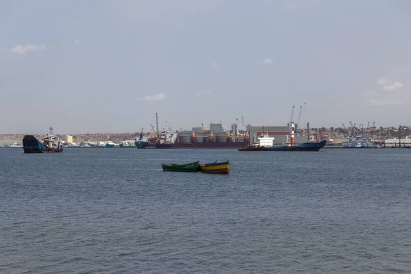 Luanda Angola - 10 13 2021: View of a fishing boats, oil tanker and Port of Luanda, port logistics center with containers as background, Luanda, Angola