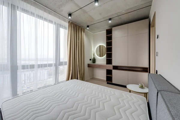 Mobilyalı ve boş yataklı modern bir yatak odası.
