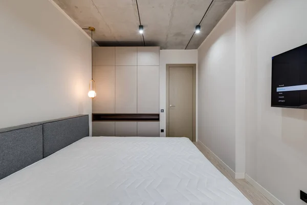 Mobilyalı ve boş yataklı modern bir yatak odası.