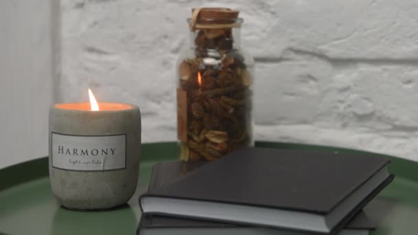 A fading candle stands on a green coffee table in the loft style or scandi — Stock Video