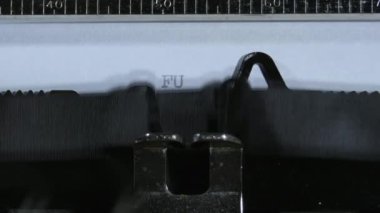 Typing the expression FUCK YOU! with an old manual typewriter