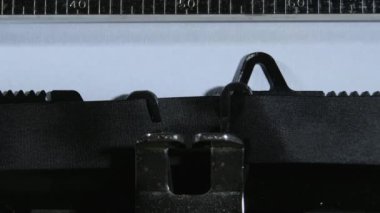 Typing the expression Fuck You with an old manual typewriter