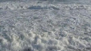 Rough waves sea with white foam