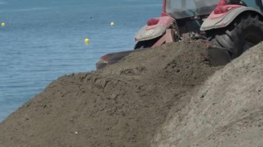 Tractor machine working in works of regeneration of beaches