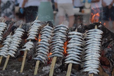 Popular barbecue with sardines espetos at grill, typical spanish food