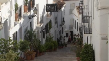 Typical andalusian white street a sunny evening in Frigiliana, Spain