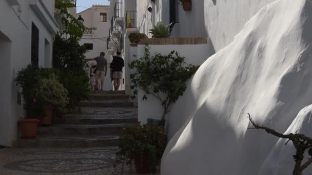 People Walking Andalusian Whitewashed Street Sunset Tilt — Stok video