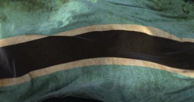 Old Botswana Flag waving at wind. Loop