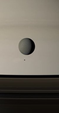 Epimetheus ve Rhea Satürn gezegeninin etrafında dönüyorlar.