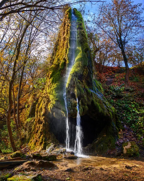 Beautiful rock waterfall in the autumn forest. Maliivtsi.