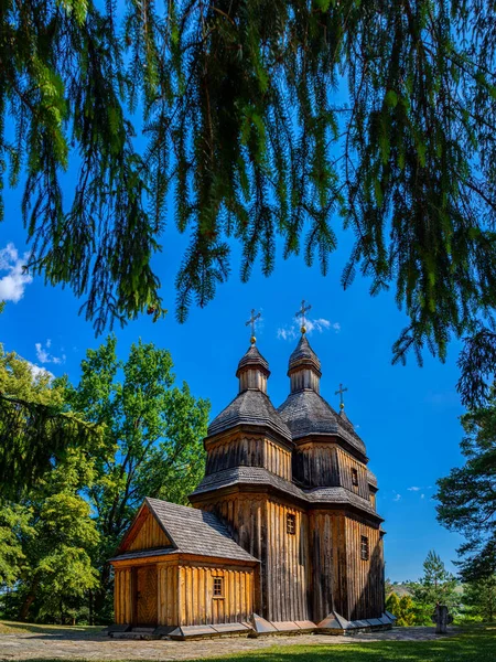 An old wooden church in Ukraine. Rural landscape with a church. Wooden Cossack Ukrainian church in the village of Zinkiv.