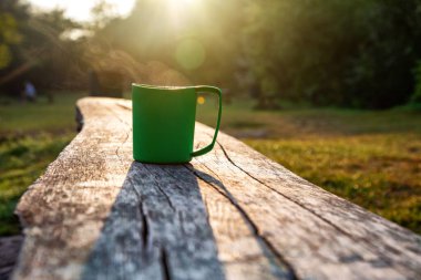 Tourist cup of coffee in the morning forest.