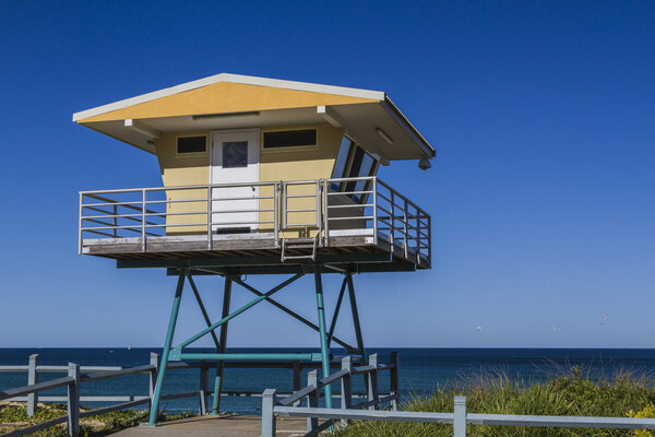 A beach Life Guard Tower on a clear blue sky day