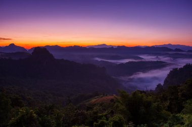 Aerial view Beautiful morning view of sunrise, golden light and mist flowing on the highland fields, Ban Cha Bo, Mae Hong Son,Thailand.