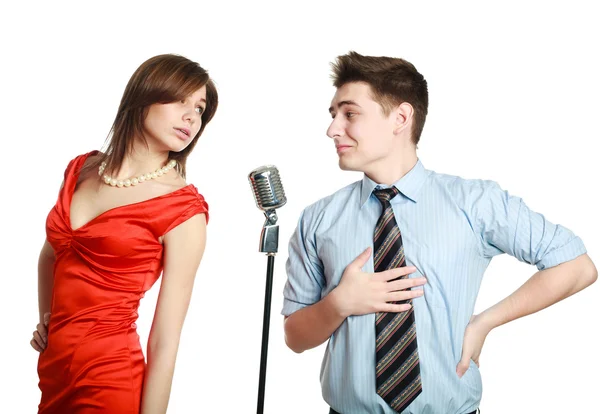 Young guy singing to a pretty girl, studio, isolated on white — Stock Photo, Image