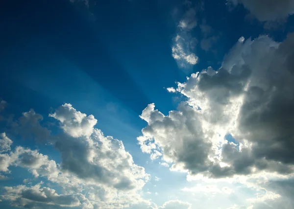 Mavi gökyüzünde kirişler güneş Bulutların arasından — Stok fotoğraf