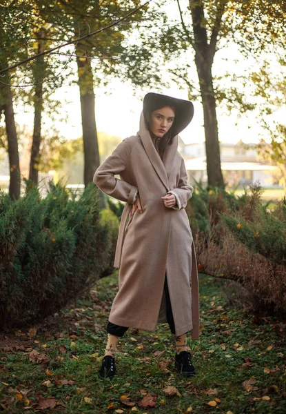 Stylish Fashionable Young Lady Beige Coat Hooded Cloak Park Background — стоковое фото