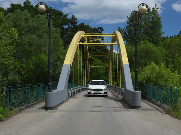 A small bridge over the river, a car ...