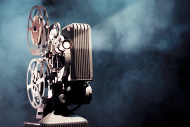 old film projector with dramatic lighting clipart
