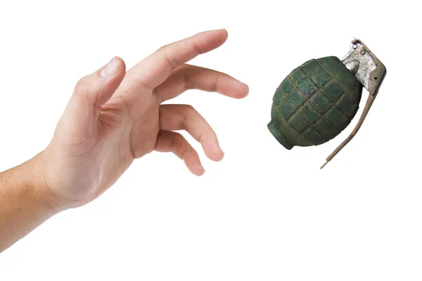 Hand throwing a green grenade on white — Stock Photo, Image