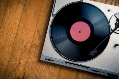 Vintage turntable with disc on wood clipart