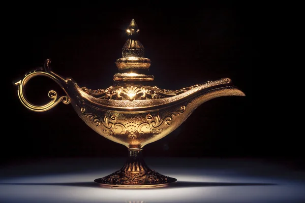 Magic Aladdin 's Genie lamp on black — стоковое фото