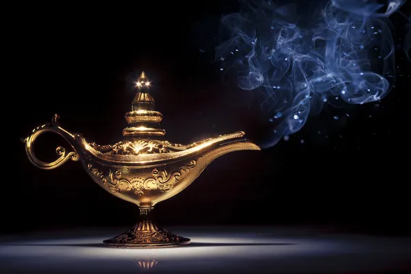 Magic Aladdin 's Genie lamp on black with smoke — стоковое фото