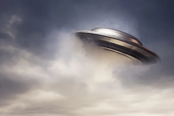 Big UFO emerging from the clouds — Stock Photo, Image