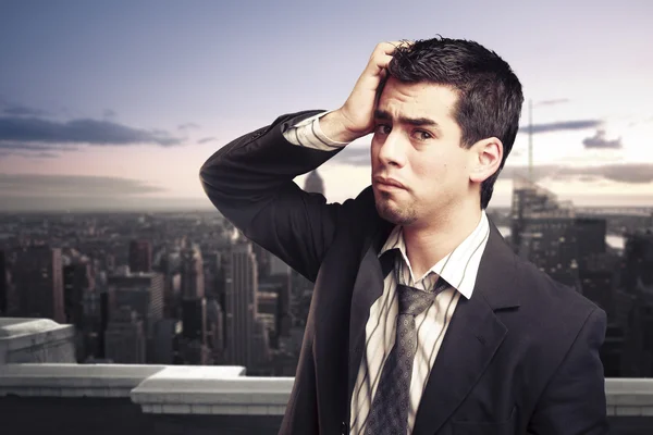 Worried businessman on top of a building in NY city — Stock Photo, Image
