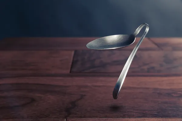 Psychokinesis concept with bent spoon — Stock Photo, Image