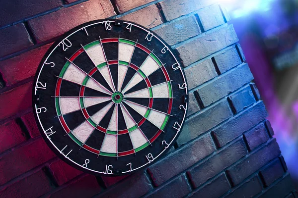 Dartboard em uma parede de tijolo — Fotografia de Stock