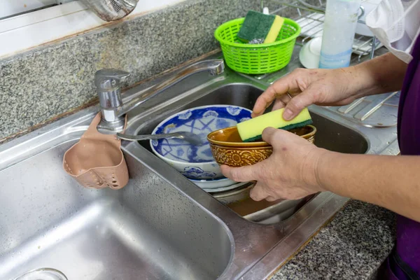 sink plate bowl tap sponge hand dirty.