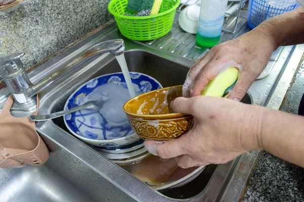 sink plate bowl tap sponge hand dirty.