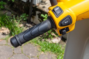 motorcycle handlebar horn yellow closeup.