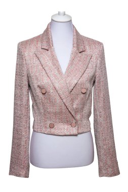 Pink female jacket. Close-up of a modern elegant stylish tweed blazer on mannequin isolated on white background. Made from virgin wool, the tweed fabric originates from Scotland.