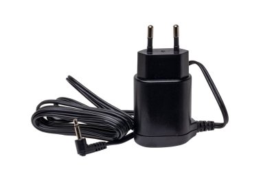 Closeup of a black AC to DC power adapter or charger for a rechargeable beard and hair clipper isolated on white background. Clipping path. Macro.
